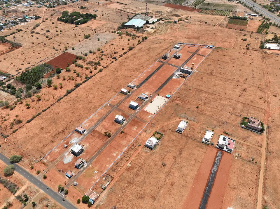 Aerial view of plot boundaries and internal roads set out across red laterite ground